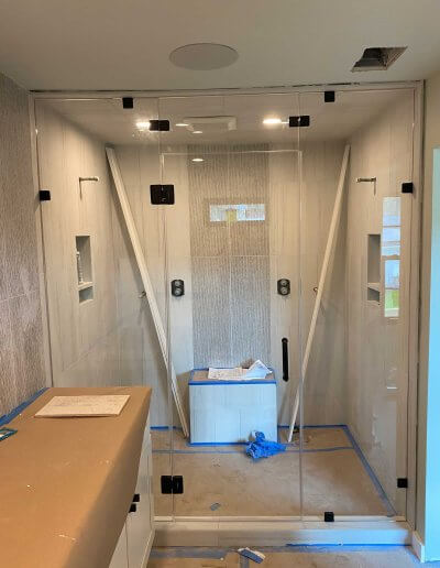 frameless glass shower enclosure. Installation in progress